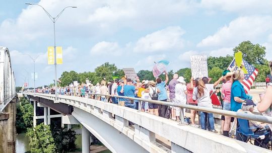 ACTIVISTS FLOOD BASTROP BRIDGE