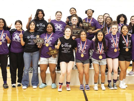 The Elgin High School girls varsity powerlifting team proudly poses together March 4 after winning the THSWPA regional powerlifting meet. Photo by Erin Anderson