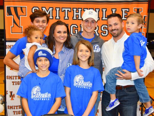 Tyson Hancock (middle) celebrates his official announcement to play for Drake University with family members. Photo courtesy of Lindsey Saunders.