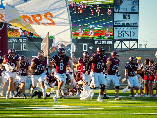 The Bastrop High School varsity football team runs through the banner on Friday, Sept. 8 prior to the Bears’ annual Homecoming game vs. Round Rock Westwood High School. Photo by Chris White of Bastrop ISD