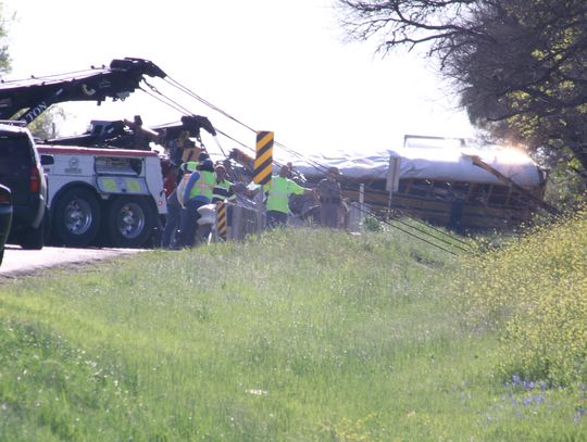 The March 22 collision involving a Hays Consolidated Independent School District bus carrying adults and preschoolers and a cement truck claimed the lives of a 5-year-old boy and an adult. The driver is being charged with criminally negligent homicide.   Photo by Jason Hennington 