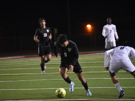 William Navarro zips past a Cougars defender in hopes of a late-game goal. Photo by Quinn Donoghue