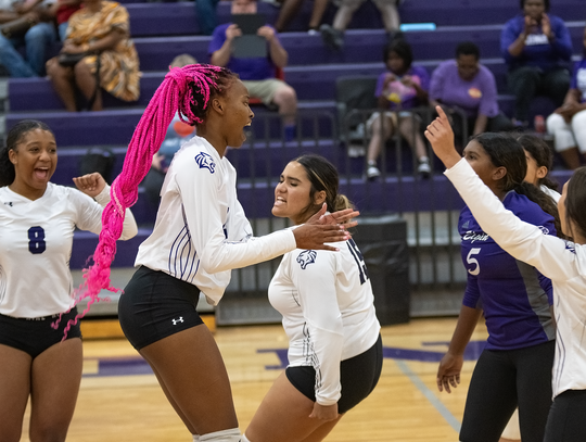 The Elgin High School varsity volleyball team celebrates together on Aug. 25 during a home match against Round Rock Meridian World School. Photo by Marcial Guajardo