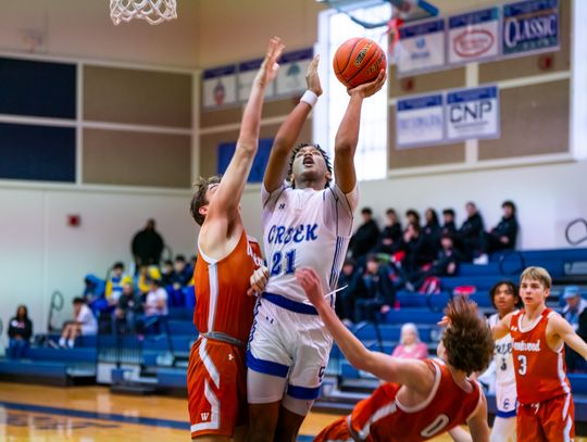 Cedar Creek High School boys varsity basketball junior Kenji Franklin (21) attacks the basket for a score Nov. 30 during the Eagles’ home tournament game versus Round Rock Westwood High School. Photo courtesy of Bastrop ISD