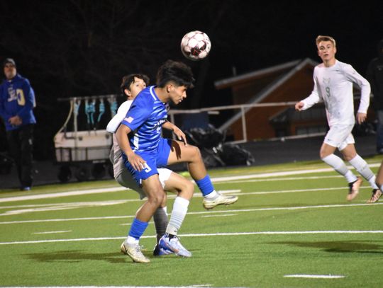 Manny Carreno Medina fights for position before heading the ball to one of his teammates. Photo by Quinn Donoghue