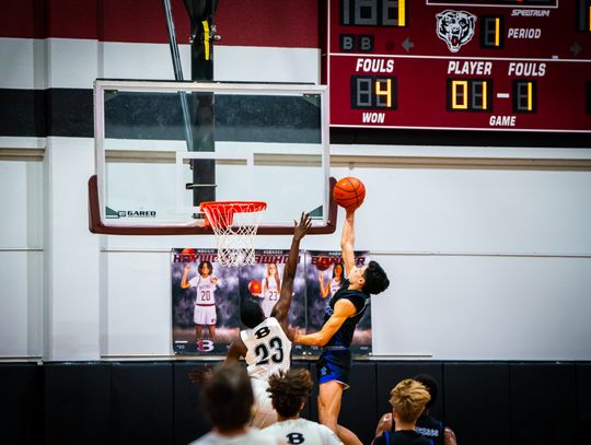 Cedar Creek High School boys varsity basketball senior Robert Conrad puts up a shot Friday, Feb. 9 against Bastrop High School senior Gregory Wilson (23) during the Eagles’ 82-38 district road win over the Bears. Photo by Chris White / Bastrop ISD