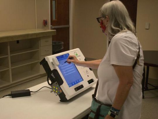 Leslie Landreth selects from a list of choices on the ballot-marking machine in this 2020 photo. Photo by Julianne Hodges