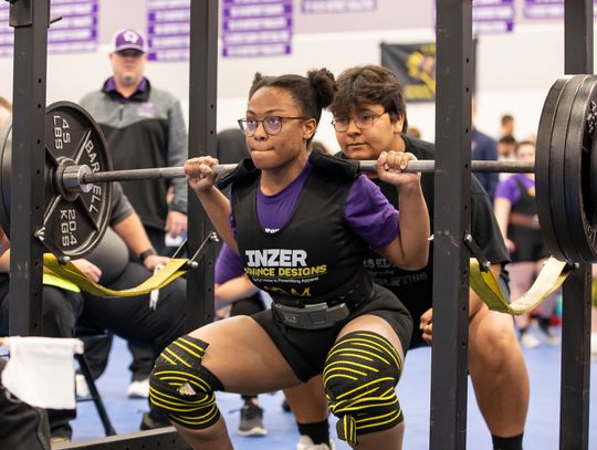 Ralyssa Enueshike squats at the regional powerlifting meet in Elgin March 4. Photo by Erin Anderson