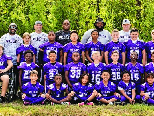 The 2023 Elgin Youth Football and Cheer Junior Football players pose with coaches. Photo courtesy of Ron Ramirez