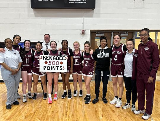 Bastrop High School girls varsity basketball sophomore Kenadee Lawhon poses with teammates and coaches Jan. 19 following the Lady Bears’ game at Georgetown High School to celebrate her 500th career point scored. Photo courtesy of Bastrop ISD