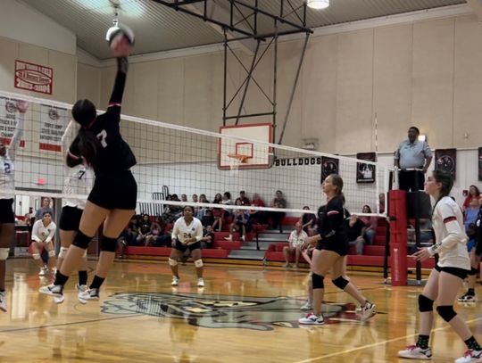 McDade High School varsity volleyball junior Lauren Glosson (7) goes up high to spike the ball on Sept. 19 during the Lady Bulldogs’ home match victory vs. Dime Box High School. Photo courtesy of Aaron Hallford