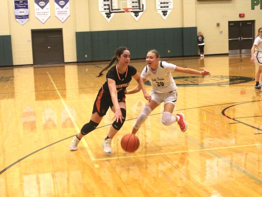 Smithville High School girls varsity basketball senior Avery Bezner drives against a defender Jan. 12 during the Lady Tigers’ district game at Taylor High School. Photo by Andrew Salmi