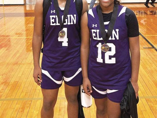 Elgin High School girls varsity basketball senior Jaylan Roberson (left) and sophomore teammate Trinity Martinez (right) happily pose together Nov. 18 at the Crockett Tournament in Austin after being selected to the all-tournament team. Photo courtesy of Elgin ISD