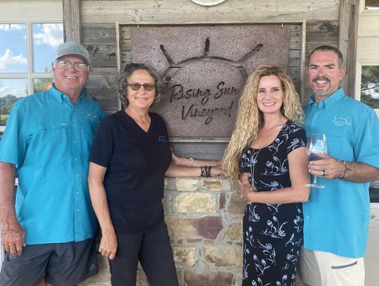 Steve and Sandy Frintz (left) enjoy a peaceful afternoon at the vineyard with their kids Bart and Tiffany. Photo courtesy of Rising Sun Vineyard.