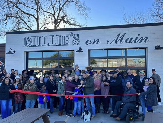 The Mauck family, with namesake family dog Millie, cutting their official ribbon. Photo courtesy Elgin Chamber of Commerce