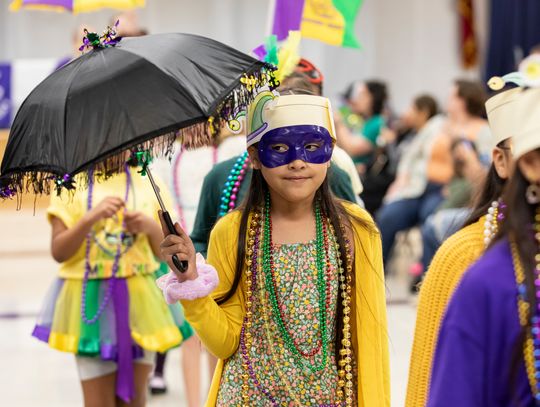 Melanie Sanchez dons festive Mardi Gras attire for the EES parade last Tuesday. Photo by Erin Anderson