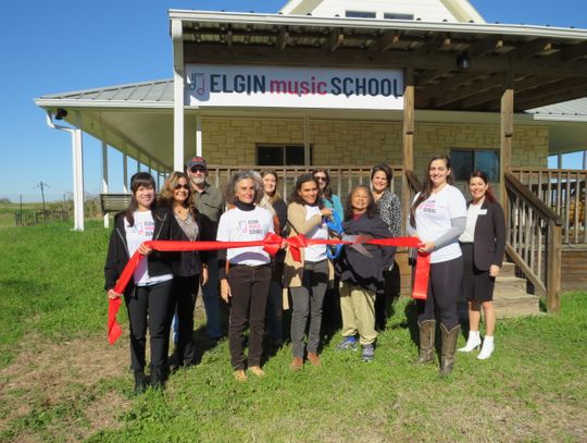 Gabrielle Rosa Amaro (middle) celebrates the opening of Elgin Music School with staff, chamber and community members. Photo by Fernando Castro.