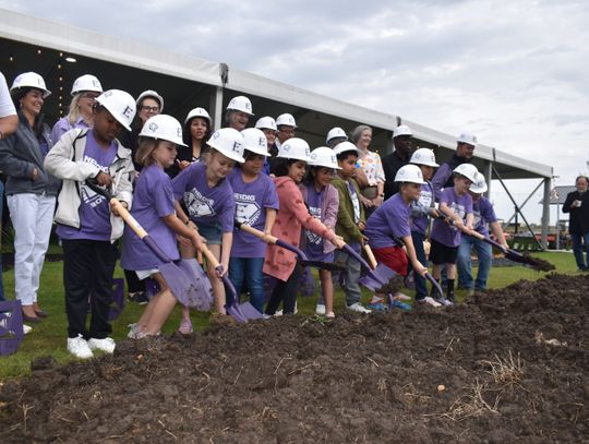 Students along with current and former school staff and school board members help break ground on Harvest Ridge Elementary School in north Elgin April 5. Pictured are, front, Jamarien Jackson, Sonny Ann Rowe, Tristyn Modesette, Mailen Mondragon, Natalie Baena Grimaldo, Presley Perez, Paul...