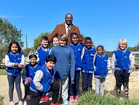  Charles Wilson with his second and third graders, out for recess in their custom TNT Academy jackets. Photo by Niko Demetriou