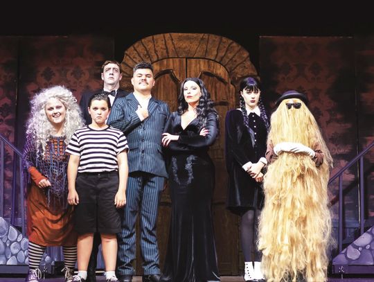 The cast of Addams Family, The Musical, in their iconic garb: Kelsey Layton, Benjamin Walk, Chase Lancaster, Jacob Layton, Aline Forastieri, Shiloh Bartee and Phoebe Bartee.