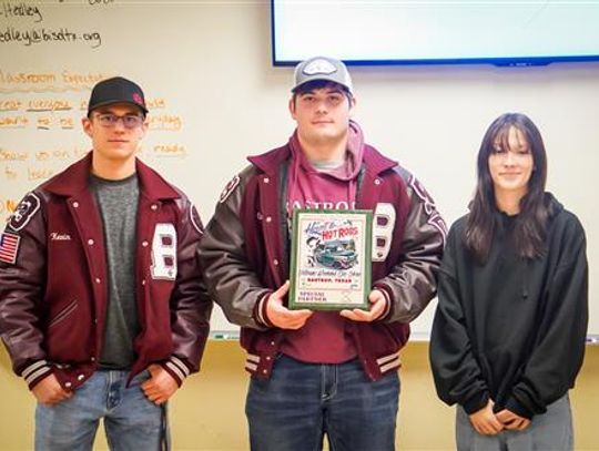 Clayton Sherman, Kevin Hoefer and Laina McDonald receive a plaque from the Bastrop Area Cruisers Feb. 3 in Bastrop for volunteer work. Courtesy photo