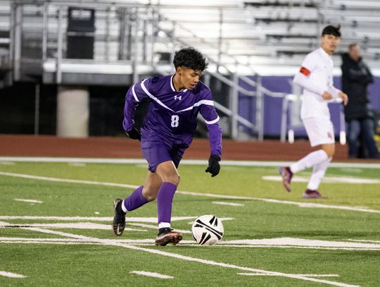 Guillermo Hernandez prepares to launch a pass downfield during Friday night’s game versus East View. Photo by Erin Anderson