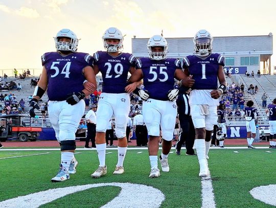 The Elgin High School varsity football captains take the field Sept. 1 prior to the Wildcats’ home game vs. Austin Akins High School. From left to right: senior Hunter Gibson, junior Jackson Clowdus, senior Dennis Lavigne and senior Nathen Lewis. Photo by Marcial Guajardo