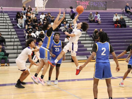 Elgin High School boys varsity basketball sophomore Tyson McFarlin puts up an acrobatic shot Jan. 17 during the Wildcats’ 66-52 victory at home versus Pflugerville High School. Photo by Jack Grames