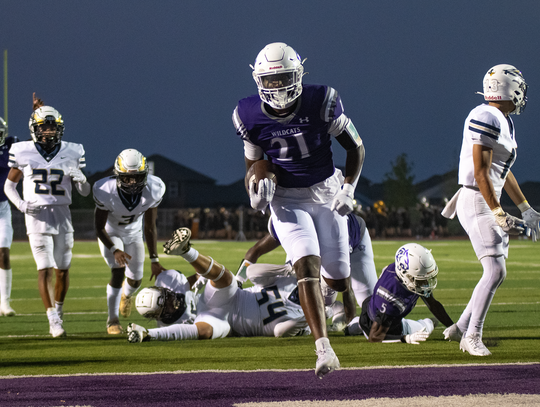 Elgin High School varsity football senior running back Darren Harper (21) crosses the goal line for a touchdown on Friday night duing the Wildcats’ dominant home victory over Austin Akins High School. Read about the Wildcats win on page 5. Photo by Marc