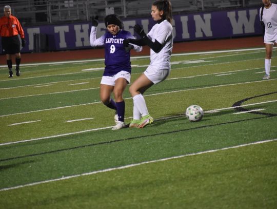 Maria Yanez (left) fights for possession against a Pflugerville defender. Photo by Quinn Donoghue