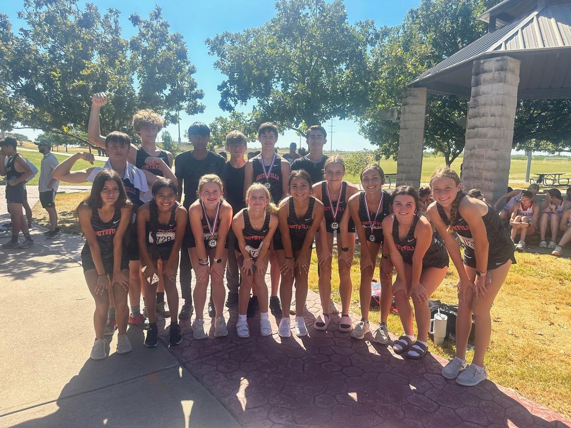 The Smithville High School varsity cross country squad happily gathers for a team photo on Sept. 8 following the Tigers and Lady Tigers competing in the Pflugerville Invitational. Photo courtesy of Smithville Lady Tiger Athletics