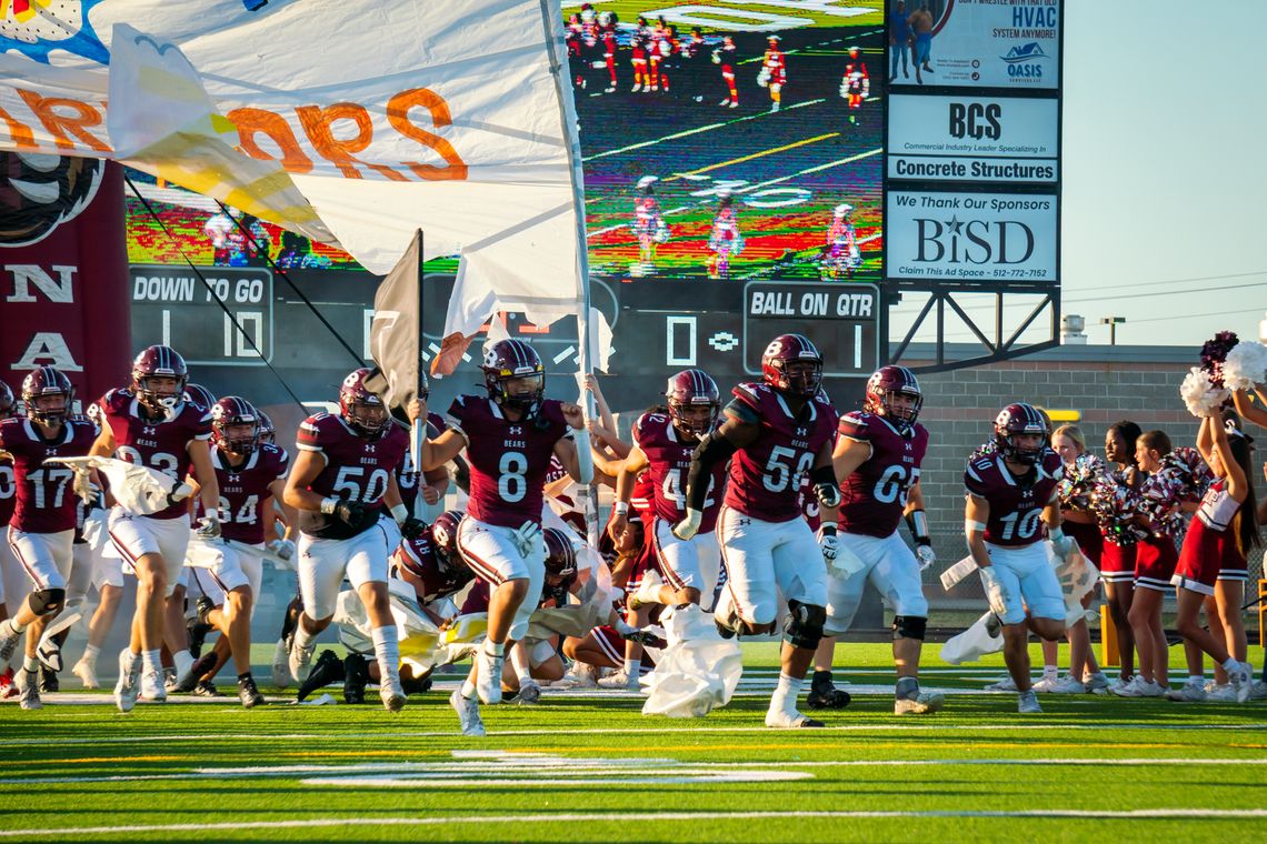 The Bastrop High School varsity football team runs through the banner on Friday, Sept. 8 prior to the Bears’ annual Homecoming game vs. Round Rock Westwood High School. Photo by Chris White of Bastrop ISD