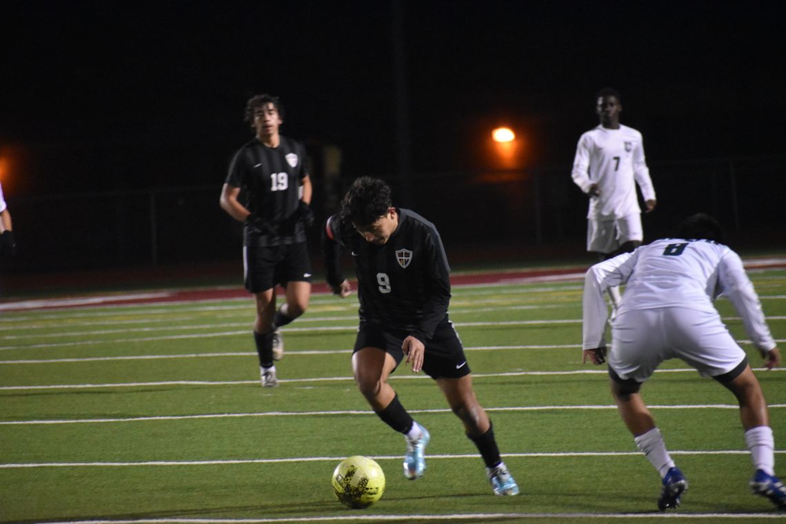 William Navarro zips past a Cougars defender in hopes of a late-game goal. Photo by Quinn Donoghue