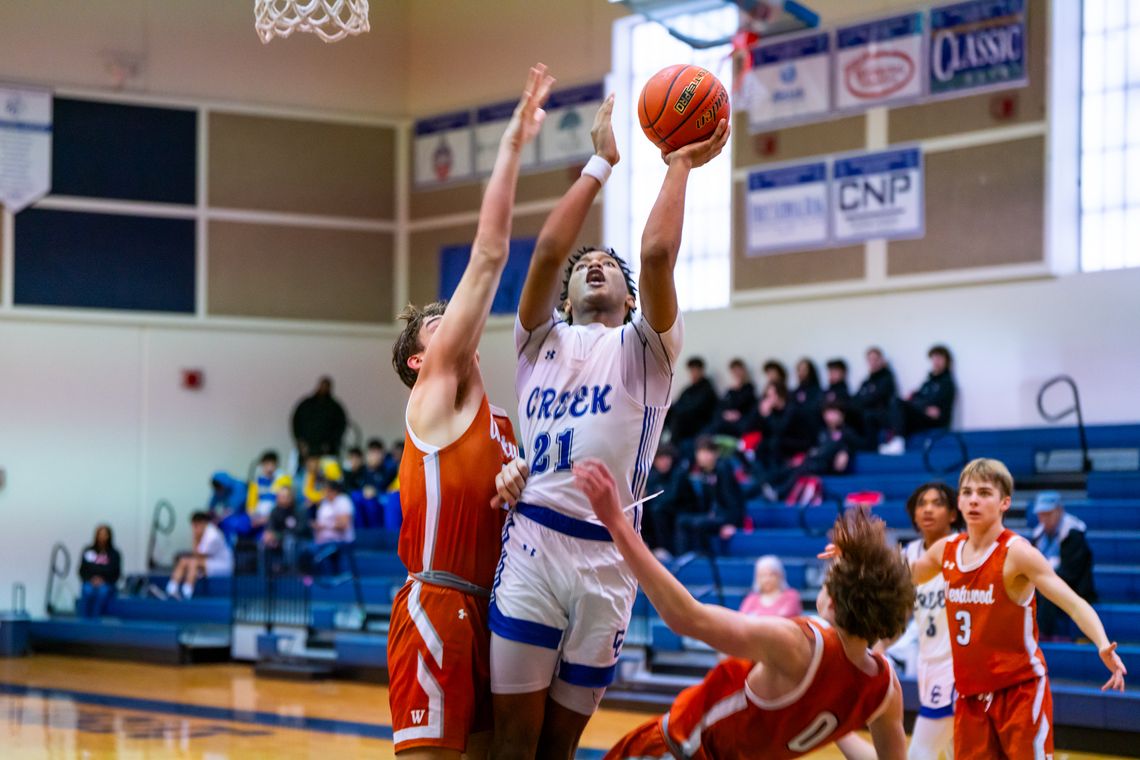 Cedar Creek High School boys varsity basketball junior Kenji Franklin (21) attacks the basket for a score Nov. 30 during the Eagles’ home tournament game versus Round Rock Westwood High School. Photo courtesy of Bastrop ISD