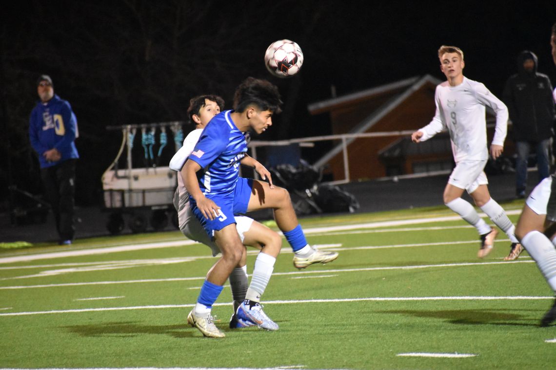 Manny Carreno Medina fights for position before heading the ball to one of his teammates. Photo by Quinn Donoghue