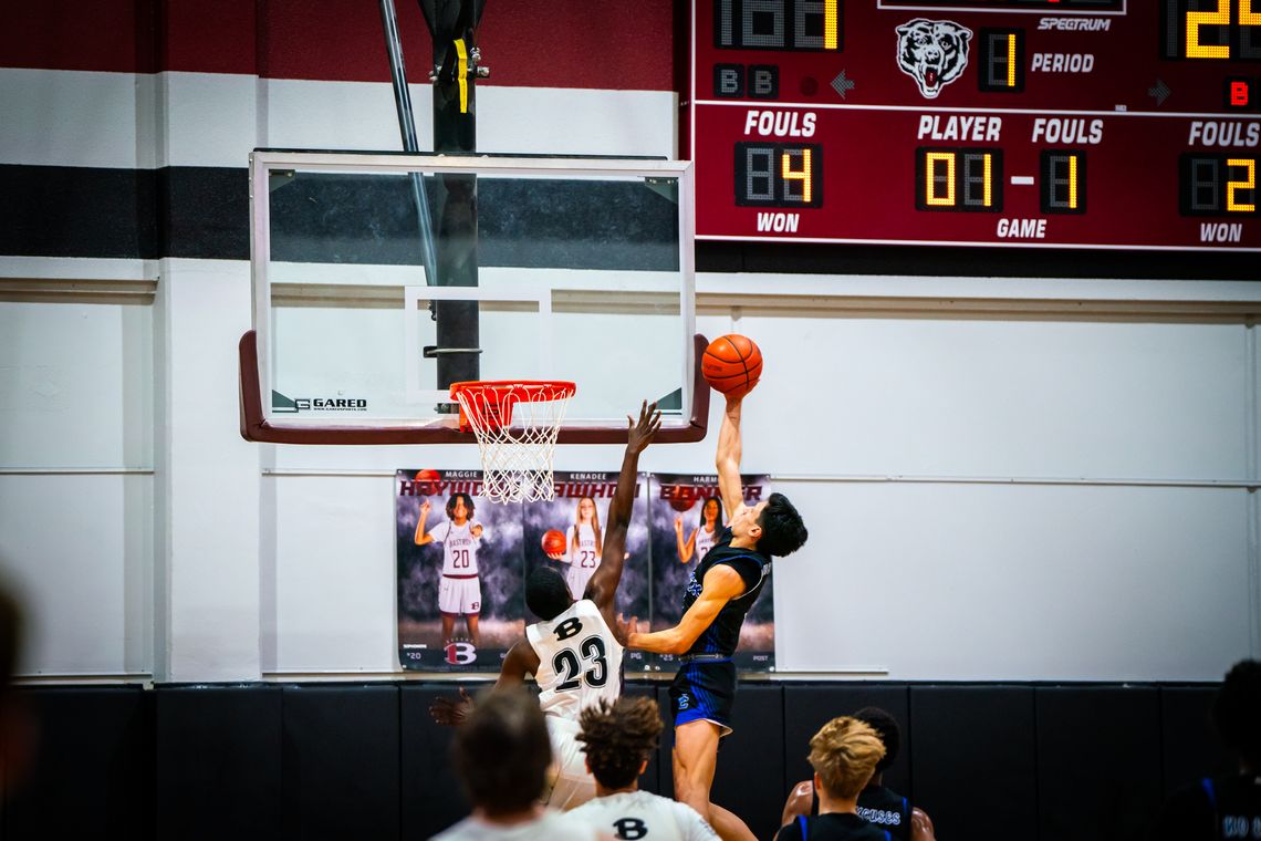 Cedar Creek High School boys varsity basketball senior Robert Conrad puts up a shot Friday, Feb. 9 against Bastrop High School senior Gregory Wilson (23) during the Eagles’ 82-38 district road win over the Bears. Photo by Chris White / Bastrop ISD