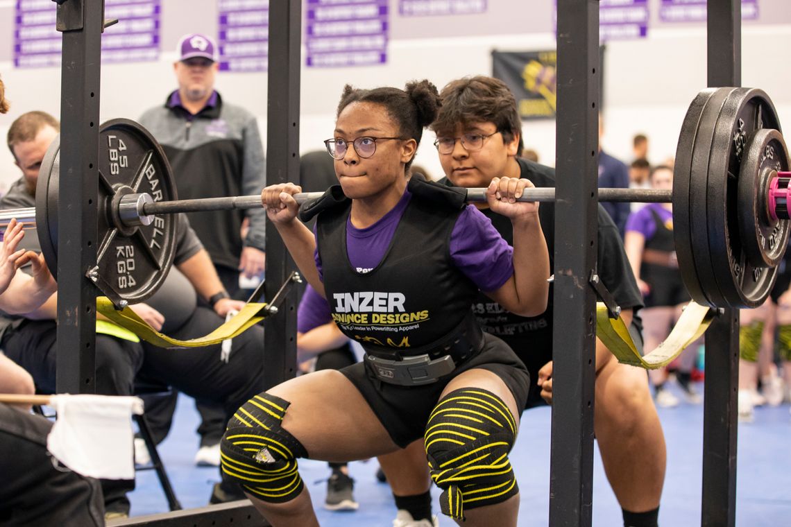 Ralyssa Enueshike squats at the regional powerlifting meet in Elgin March 4. Photo by Erin Anderson