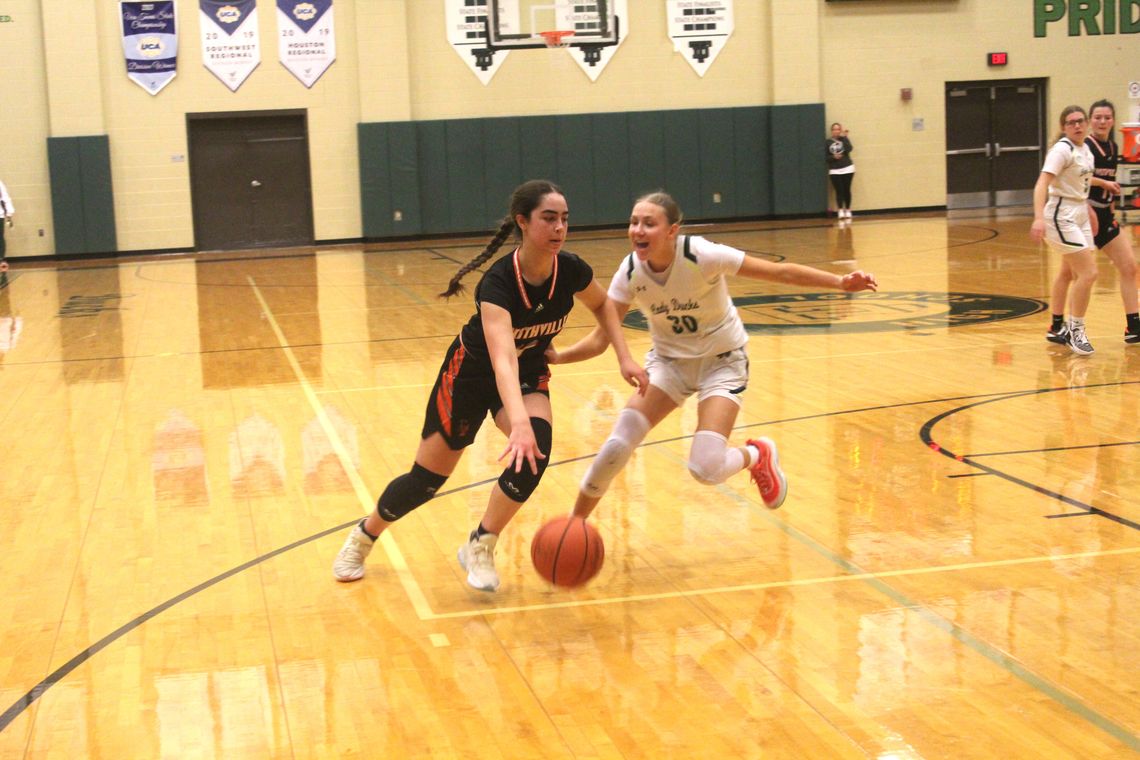 Smithville High School girls varsity basketball senior Avery Bezner drives against a defender Jan. 12 during the Lady Tigers’ district game at Taylor High School. Photo by Andrew Salmi