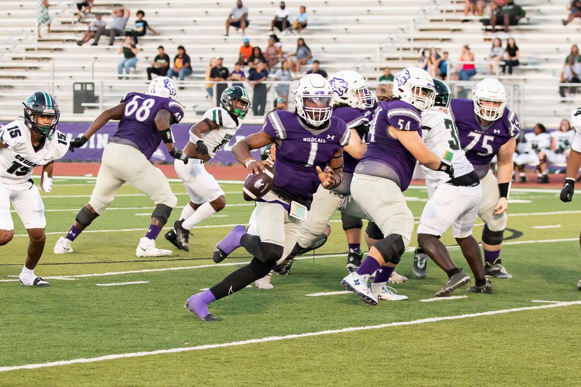 Elgin High School varsity football senior quarterback Nathen Lewis (1) scrambles for yardage Sept. 22, 2023, during the Wildcats’ dominant 50-28 victory at home over Pflugerville Connally High School. Photo by Erin Anderson