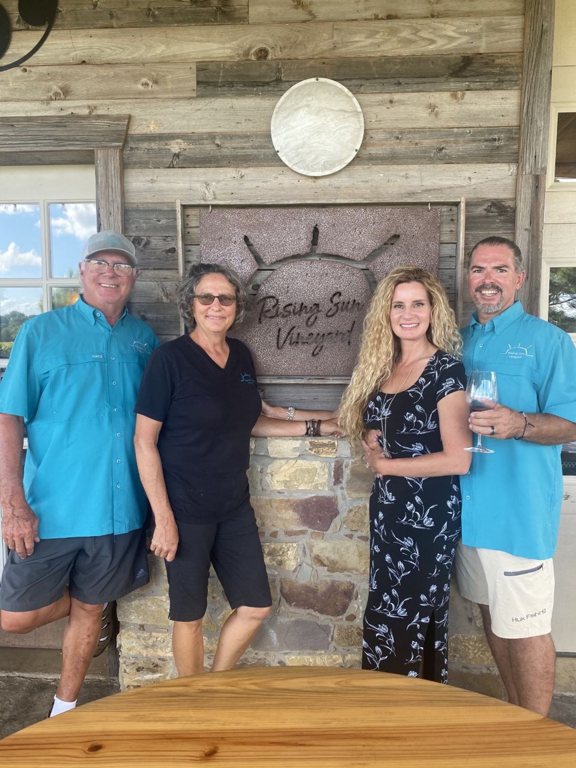 Steve and Sandy Frintz (left) enjoy a peaceful afternoon at the vineyard with their kids Bart and Tiffany. Photo courtesy of Rising Sun Vineyard.