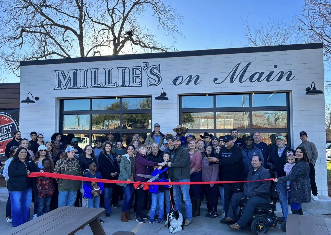 The Mauck family, with namesake family dog Millie, cutting their official ribbon. Photo courtesy Elgin Chamber of Commerce