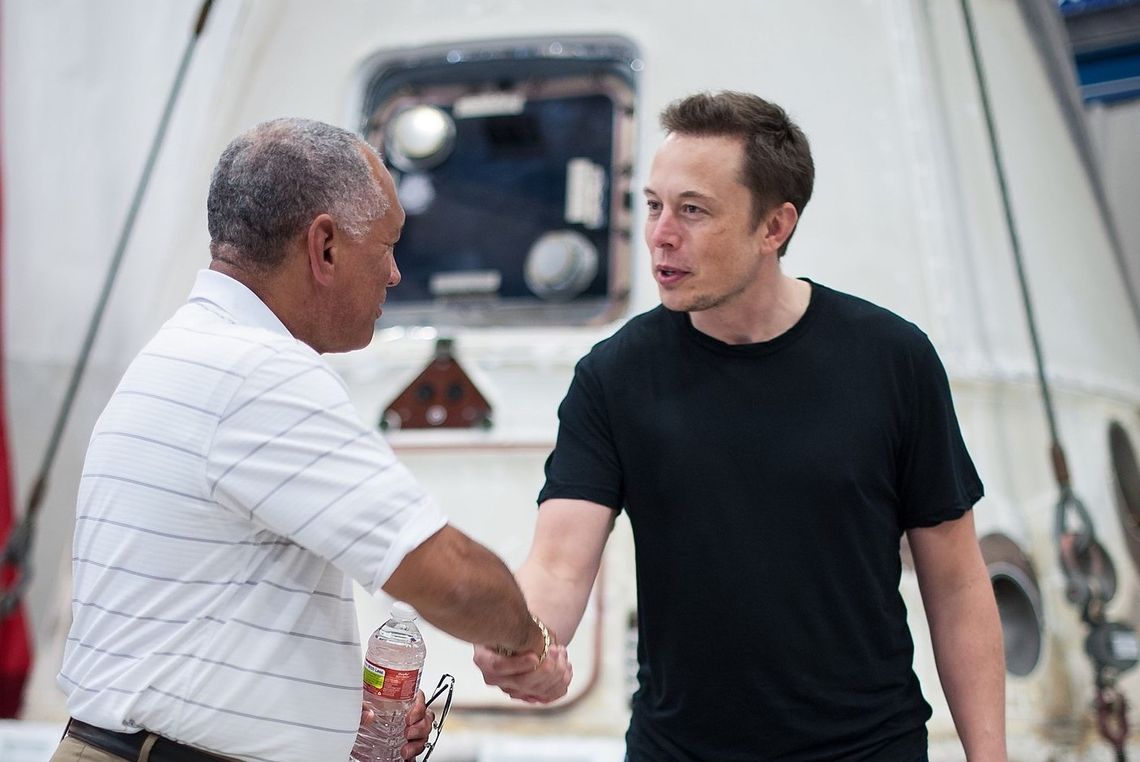 NASA Administrator Charles Bolden, left, congratulates SpaceX CEO and Chief Designer Elon Musk in front of the historic Dragon capsule that returned to Earth on May 31 following the first successful mission by a private company to carry supplies to the International Space Station on June 1...