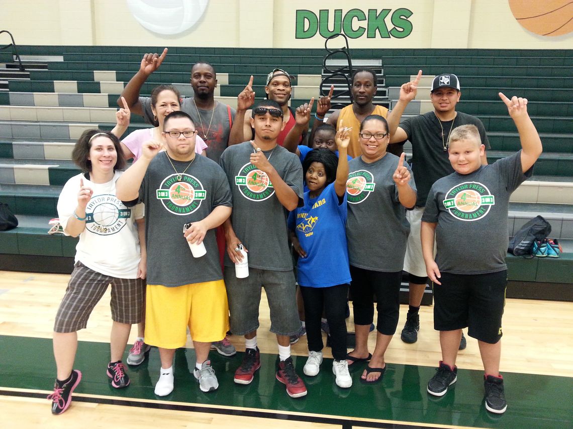 The members of team Flight celebrate with the Shining Stars after the 3-on-3 basketball tournament in 2016.     Photo by Jason Hennington