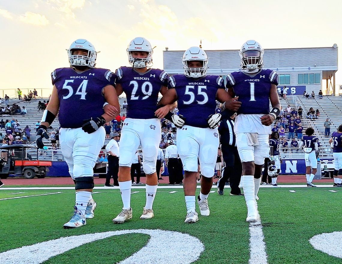 The Elgin High School varsity football captains take the field Sept. 1 prior to the Wildcats’ home game vs. Austin Akins High School. From left to right: senior Hunter Gibson, junior Jackson Clowdus, senior Dennis Lavigne and senior Nathen Lewis. Photo by Marcial Guajardo