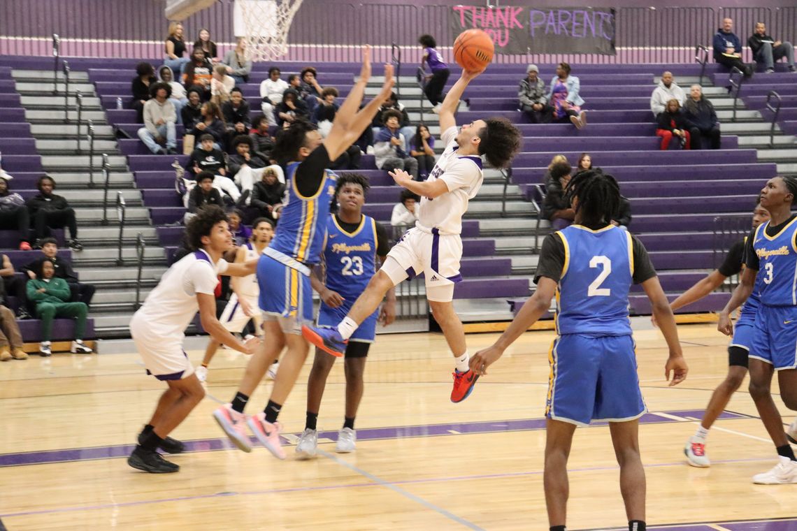 Elgin High School boys varsity basketball sophomore Tyson McFarlin puts up an acrobatic shot Jan. 17 during the Wildcats’ 66-52 victory at home versus Pflugerville High School. Photo by Jack Grames