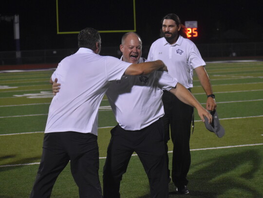 Head football coach Heath Clawson celebrates after their opening game win against Lampasas, marking their first victory since November of 2020.