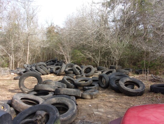 Tires litter a Cedar Creek property after being illegally dumped at the location.   Facebook / Bastrop County Sheriff’s Office