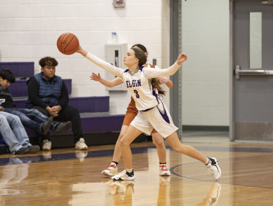 Meta Elliott showcases some solid defense as she jumps in front of a Hutto player to deflect the pass. Photo by Erin Anderson