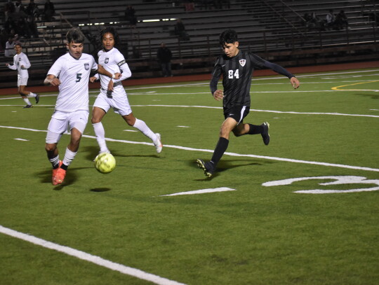 Abel Perez (right) fights for a loose ball against Pflugerville Connally. Photo by Quinn Donoghue