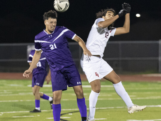 Anthony Jones leaps in the air and battles a Patriots player for possession. Photo by Erin Anderson